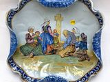 an image of a blue and white plate with a picture of a group of people