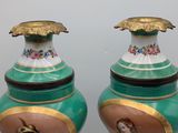 two vases that have pictures of people on them