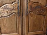 a wooden armoire with a carved design on it