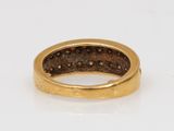 a close up of a gold ring on a white surface