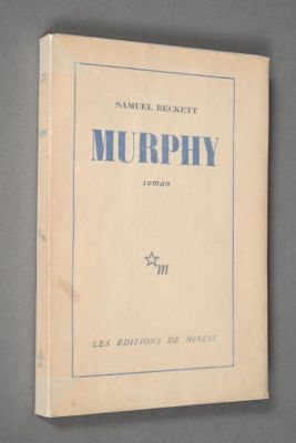 an old book with blue writing on it sitting on top of a table