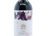 a bottle of red wine sitting on top of a white table