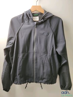 an image of a jacket hanging on a hanger on a wall