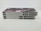 three black magick books stacked on top of each other