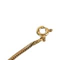 a close up of a gold bracelet on a white background