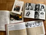 three open books on the table with pictures of people on them
