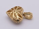 an image of a gold heart shaped pendant on a white background