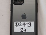 an iphone case with a sticker on it sitting on a bed
