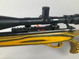 a close up of a rifle with a scope on it