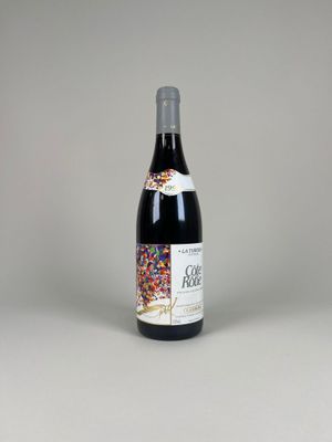 the bottle of wine is sitting on the table with a white background
