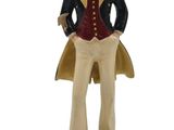 figurine of a man in a top hat and coat with his hands in his pockets