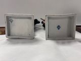 two white dishes with blue designs on them sitting on a table