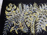 a picture of a black and yellow painting on a table