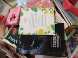 a pile of books sitting on a table next to a cup of coffee