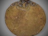 an image of a gold plate with holes in it