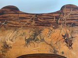a wooden bench with a painting on the back of it