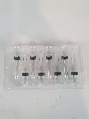 six empty bottles in a plastic container on a table