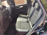 the back seats of a car with a seat belt in the back of it