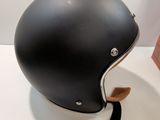 a helmet on a white table with a black strap
