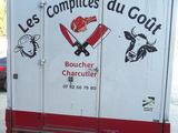 a delivery truck that has stickers on the back of it