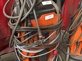 a stack of welding equipment on a cart in a garage