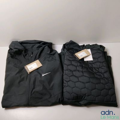 a pair of black nike jackets sitting on top of a white table