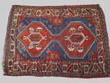 an old rug with a red and blue design on a white background