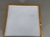 a small blue and gold plate with a gold border