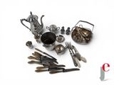 a lot of silverware on a white surface