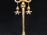 an antique brass lamp with a white shade on a black background