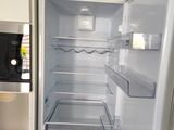 an open refrigerator in a kitchen with a microwave on the counter