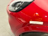 a close up of a red car with a sticker on it