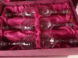 six wine glasses in a pink box on a table