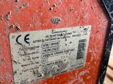 a red suitcase with a sticker on it sitting on a wooden bench