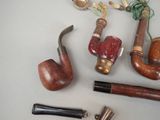 many different types of smoking pipes on the table