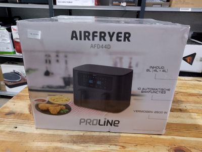 an air fryer sitting on a wooden table in a store