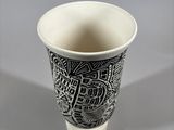 a black and white cup with a pattern on it
