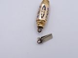 a small gold object with a blue and white design on it