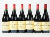six bouteilles de vin sont alignées sur une surface blanche