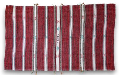 a close up of a red and white striped towel hanging on a wall