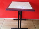 table with a number on it in front of a red wall