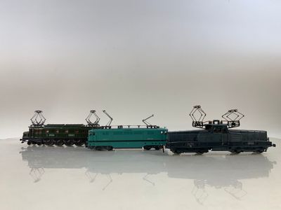trois petits trains posés sur une surface blanche