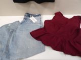 a red top and a pair of jeans on a table