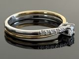 a ring with a diamond on top of it on a table