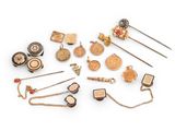 many different types of brooches and pins on a white surface