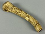 a small wooden stick with a carving of a man on it