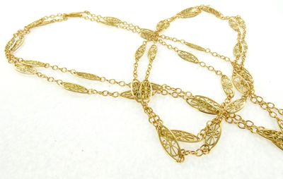 gold plated chain with a leaf pendant on a white background