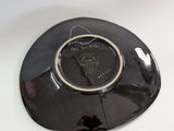 a black plate with a picture of a horse on it