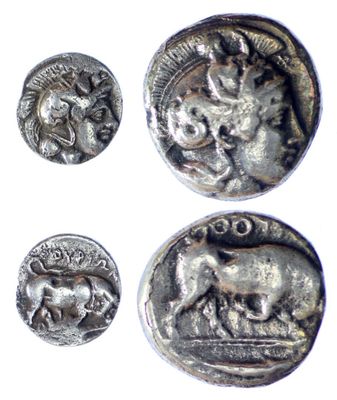 three silver coins with animals on them on a white surface