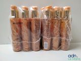 several bottles of makeup products wrapped in plastic bags on a table